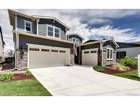 Two-story home featuring an attached three-car garage and stone accents at 6521 Barnstead Dr, Castle Pines, CO 80108