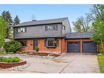 Beautifully landscaped home with a brick and siding exterior, a spacious driveway, and a two-car garage at 2448 S Leyden St, Denver, CO 80222