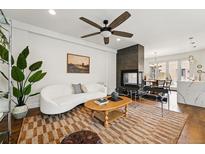 Bright living room featuring modern decor, a fireplace, and stylish furnishings at 3941 Vallejo St, Denver, CO 80211