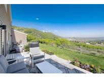 Enjoy outdoor living on this beautiful patio with mountain views, a grill, and comfortable seating at 6980 Fargo Trl, Littleton, CO 80125