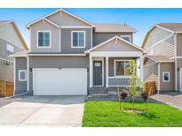Two-story house with gray siding, white garage door, and landscaped lawn at 15963 Syracuse St, Thornton, CO 80602
