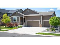 Charming single Gathering home with a large driveway and well-manicured lawn at 18067 E Anthem Dr, Parker, CO 80134