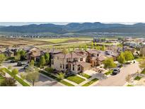 Stunning aerial view of a suburban neighborhood with well-maintained lawns and mountain views at 15218 W La Salle Ave, Lakewood, CO 80228