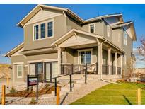 Two-story house with gray siding, a front porch, and a landscaped lawn at 4616 Girardot Pt, Castle Rock, CO 80104