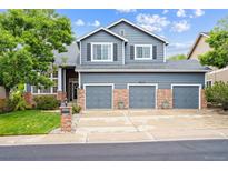 Charming two-story home with a three-car garage and a well-maintained lawn at 13560 Detroit St, Thornton, CO 80241