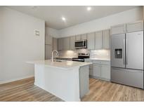 Modern kitchen with stainless steel appliances and an island at 487 Interlocken Blvd # 407, Broomfield, CO 80021