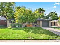 Charming ranch-style home featuring a well-manicured lawn and lovely curb appeal at 1585 S Jasmine St, Denver, CO 80224