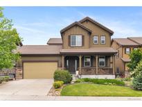 Charming two-story home with a covered porch, landscaped yard, and a two-car garage at 10546 Sundial Rim Rd, Highlands Ranch, CO 80126