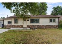 Charming single-story home featuring stone accents and a well-maintained front yard at 4972 W Custer Pl, Denver, CO 80219
