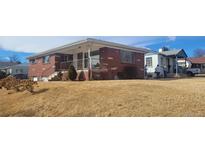 Charming brick home with a covered porch and a well-maintained front yard, ideal for suburban living at 3601 W 80Th Ave, Westminster, CO 80031
