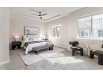 Bright main bedroom features tray ceiling, large windows, and neutral decor for a serene retreat at 8183 S Yosemite Ct, Centennial, CO 80112