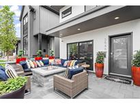 Inviting front porch with comfortable seating around a stone fire pit at 3540 Pecos St, Denver, CO 80211