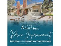 Charming two-story house featuring a brick chimney, a well-kept front yard, and a light-colored wooden fence at 9957 Grove Way # F, Westminster, CO 80031