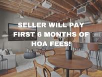 Charming living area with hardwood floors, exposed beams, and comfortable seating at 1800 Lawrence St # 303, Denver, CO 80202