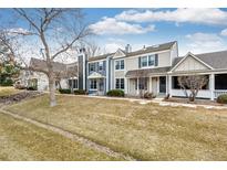 Charming townhouse exterior featuring a well-maintained lawn and varied architectural details at 19709 Rosewood Ct, Parker, CO 80138