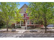 Charming two-story home with inviting front porch and well-maintained landscaping at 2502 Alton St, Denver, CO 80238