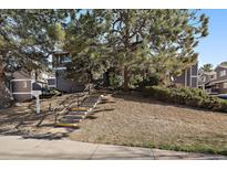 Charming multi-level townhome featuring lush landscaping and a welcoming entrance at 6585 W 84Th Way # 120, Arvada, CO 80003