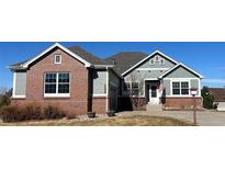 Charming home featuring brick and gray siding and a well-maintained front yard at 22725 E Long Dr, Aurora, CO 80016