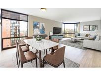 Bright living room with city views and hardwood floors at 1625 Larimer St # 1001, Denver, CO 80202