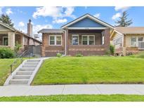 Charming brick home featuring a well-maintained lawn and inviting front porch at 3334 W 37Th Ave, Denver, CO 80211