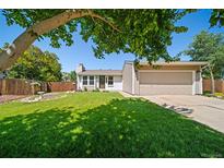 Charming single-story home features a well-manicured lawn and attached two car garage at 18159 E Crestline Cir, Centennial, CO 80015
