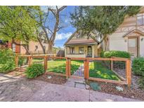 Charming home features a well-manicured front yard, complemented by a stylish fence and lush landscaping at 1726 N Lafayette St, Denver, CO 80218