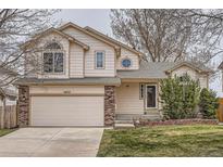 Charming two-story home featuring a two-car garage, manicured lawn, and inviting front entrance at 4032 S Lisbon Way, Aurora, CO 80013