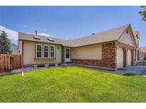 Charming single-Gathering home featuring a well-manicured lawn and an attached two-car garage at 4548 Gibraltar Way, Denver, CO 80249