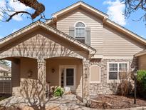 Charming two-story home featuring a cozy front porch and stone accents at 10105 Grove Loop # D, Westminster, CO 80031