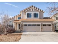 Charming two-story home featuring a three-car garage and neutral-colored siding, enhancing its curb appeal at 5857 S Zante Cir, Aurora, CO 80015