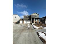 Beautiful two-story home with a three car garage and covered front porch at 7435 E 159Th Pl, Thornton, CO 80602