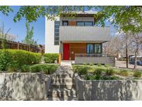 Contemporary home featuring clean lines, red front door, and professional landscaping at 1801 W 33Rd Ave, Denver, CO 80211