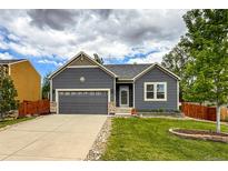 Charming single-Gathering home featuring a well-maintained lawn, two-car garage, and a beautifully landscaped front yard at 13642 Wrangler Way, Mead, CO 80542