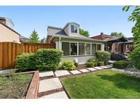 Charming home with well-manicured lawn, lush greenery, and stone walkway leading to sunroom at 4729 W 32Nd Ave, Denver, CO 80212