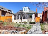 Charming home featuring a well-manicured front yard, complemented by a unique decorative tree and a cozy, inviting walkway at 4729 W 32Nd Ave, Denver, CO 80212