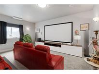 Comfortable theater room with a large screen and seating for movie nights at 7823 E 130Th Pl, Thornton, CO 80602
