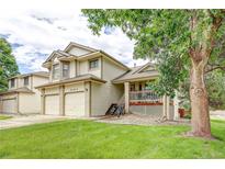 Charming two-story home featuring a well-manicured lawn and a welcoming front porch at 5185 E Weaver Dr, Centennial, CO 80121
