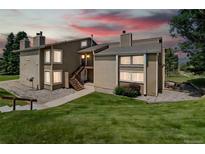 Inviting exterior view of a two-story condo featuring well-kept landscaping and a private entrance at 1140 Magic Lamp Way # 4, Monument, CO 80132