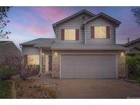 Charming two-story home with a two-car garage, red shutters, and low maintenance rock landscaping at 5130 S Wenatchee St, Aurora, CO 80015