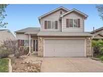 Charming two-story home with a two-car garage, red shutters, and low maintenance rock landscaping at 5130 S Wenatchee St, Aurora, CO 80015