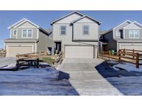 Two-story townhome with attached garage and small fenced yard at 28418 E 8Th Pl, Watkins, CO 80137