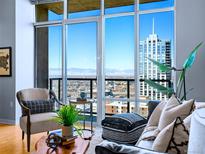 Bright living room with floor to ceiling windows and city views at 891 14Th St # 3704, Denver, CO 80202