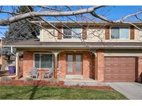 Brick home with double front doors and attached garage at 6631 E Ithaca Pl, Denver, CO 80237