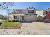 Charming two-story home with a well-manicured lawn and inviting front porch at 21642 E 55Th Ave, Denver, CO 80249