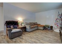 Cozy living room featuring hardwood floors and ample seating at 6651 Albion St, Commerce City, CO 80022