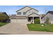 Charming two-story home featuring a three-car garage and well-manicured front yard at 3978 Aspen Hollow Ct, Castle Rock, CO 80104