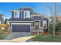 Charming two-story home with a well-maintained front yard and a two-car garage at 5519 Fullerton Cir, Highlands Ranch, CO 80130