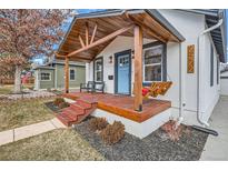 Charming home featuring a cozy front porch with wooden beams and a porch swing at 2572 Chase St, Edgewater, CO 80214