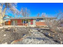 Charming single-story home featuring a brick facade, covered entryway, and well-maintained front yard at 5442 S Cedar St, Littleton, CO 80120