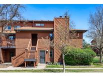 Charming two-story townhome featuring a wood exterior, well-manicured lawn, and an inviting entrance at 540 S Forest St # 5-204, Denver, CO 80246